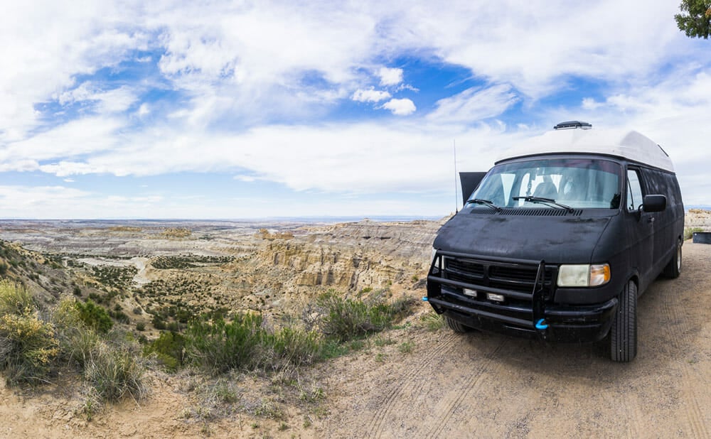 Campervan conversion parked on a cliff next to Angel Peak