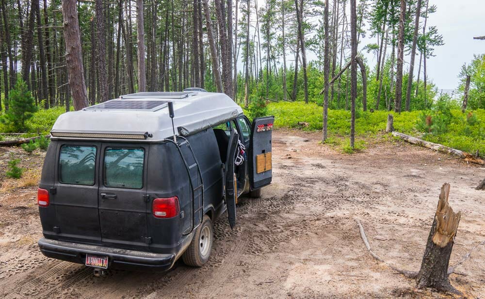 homemade conversion van parked in a camping site in michigan