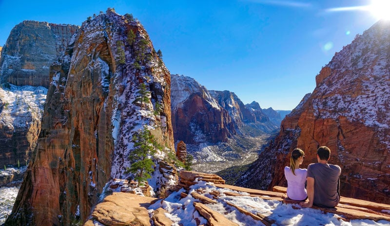 picture of couple hiking to the top of angel's landing during winter