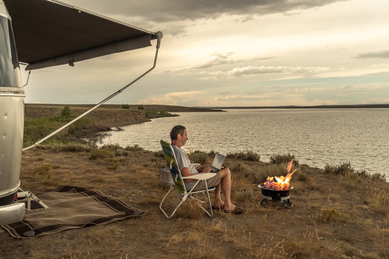 portable fire pit on a beach next to an airstream RV motorhome