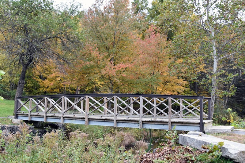 bridge across a hiking trail in connecticut run by the national park service