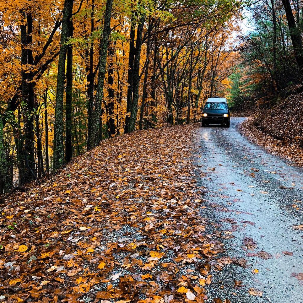 driving in a camper van conversion in the fall colors