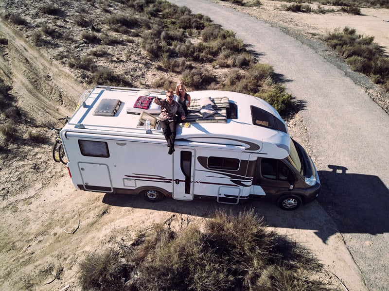 couple sitting on a camper roof