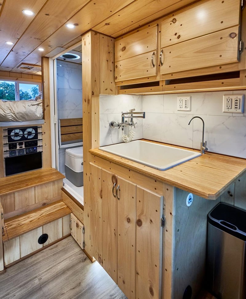 camper van with shower and bathroom sink and toilet installed