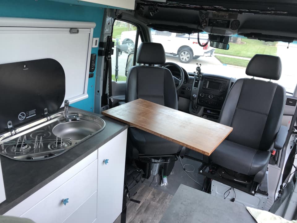 swivel seats and table in a diy camper van conversion build