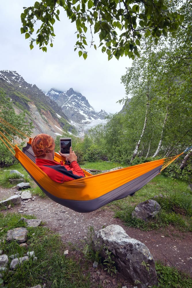 hanging a portable hammock while camping in the mountains