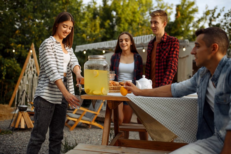 couples drinking ice cold lemonade on a camping trip