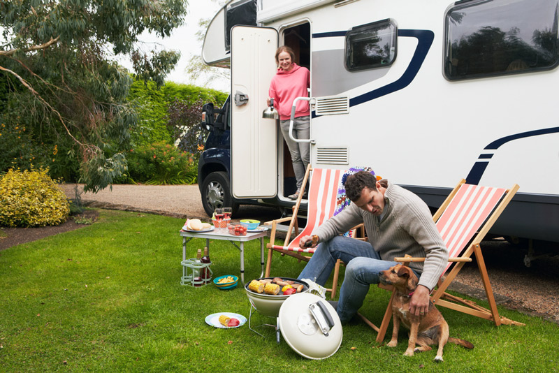 rv camping couple cooking dinner and making drinks with a portable ice maker