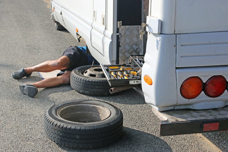 changing a flat tire on an rv camper - what to pack in an rv emergency toolbox