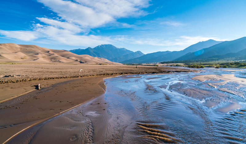 river running through great sand dunes national park in colorado