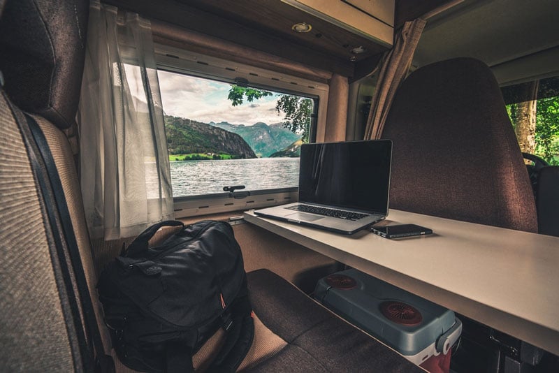 digital nomad working on the internet in a camper van