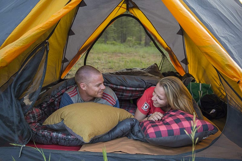 couple tent camping with a double wide sleeping bag