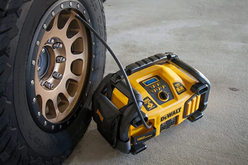 filling a tire using an air compressor on a portable jump starter