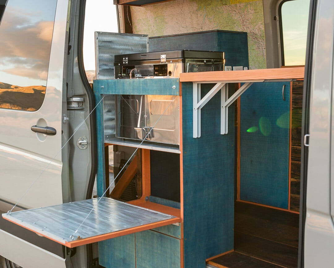 Fold out shelving in a diy camper van conversion