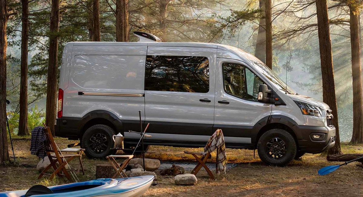 ford transit trail camper van parked at a campground