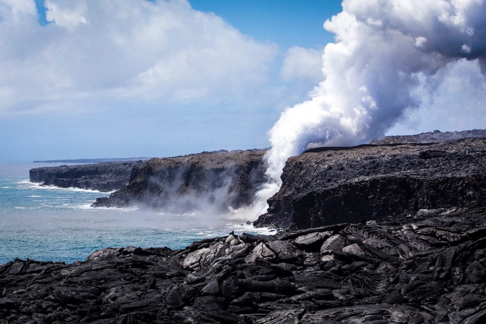 steam rising from the pacific ocean in hawaii volcanos national park