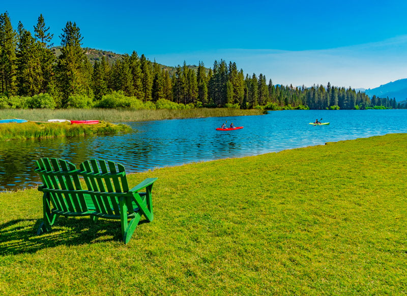 paddling a kayak in hume lake between sequoia and kings canyon national park california