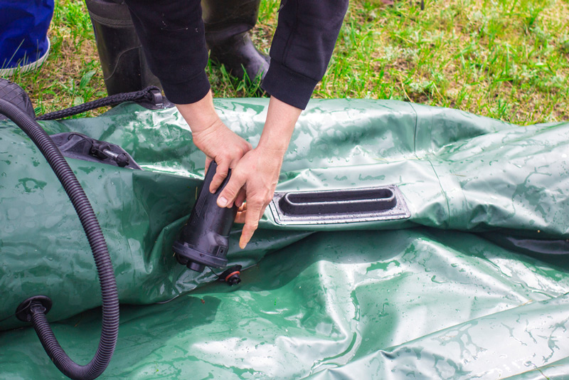 pumping up an inflatable fishing kayak