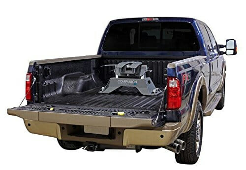 A jaw hitch sits on rails in the bed of a truck