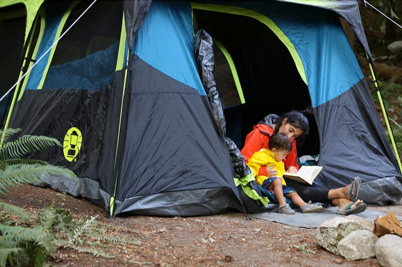 family with kids camping in a blackout tent