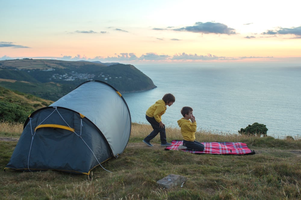 Kids playing near a family sized instant pop up tent