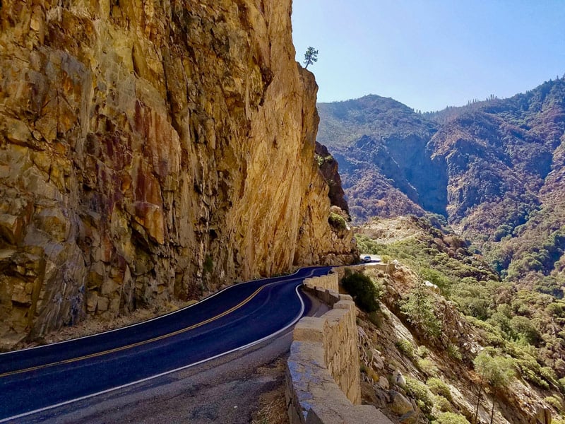 car driving on the kings canyon scenic byway in kings canyon national park