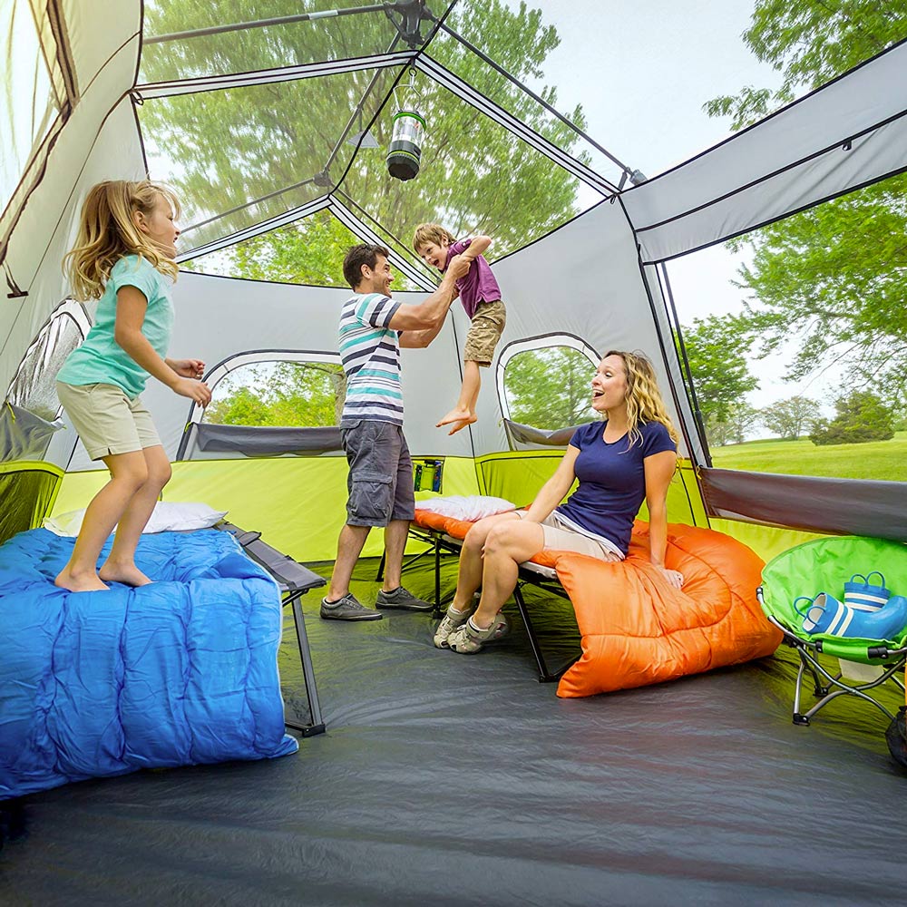 Large camping tent with family playing inside