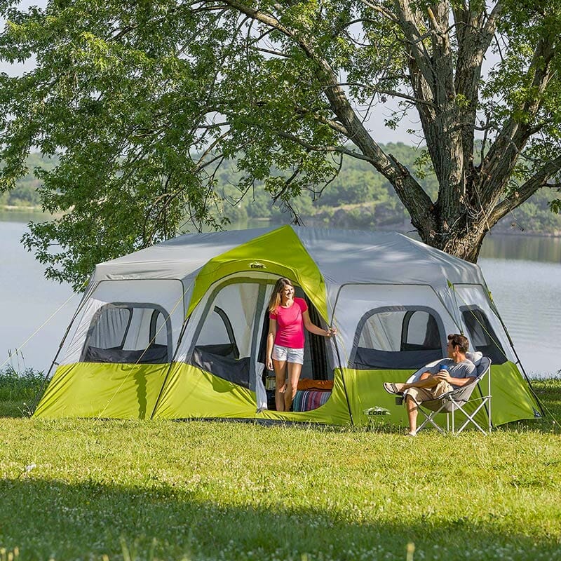 girl walking out of a large family camping tent