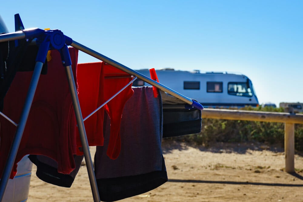 using a portable washing machine to clean clothes outdoors