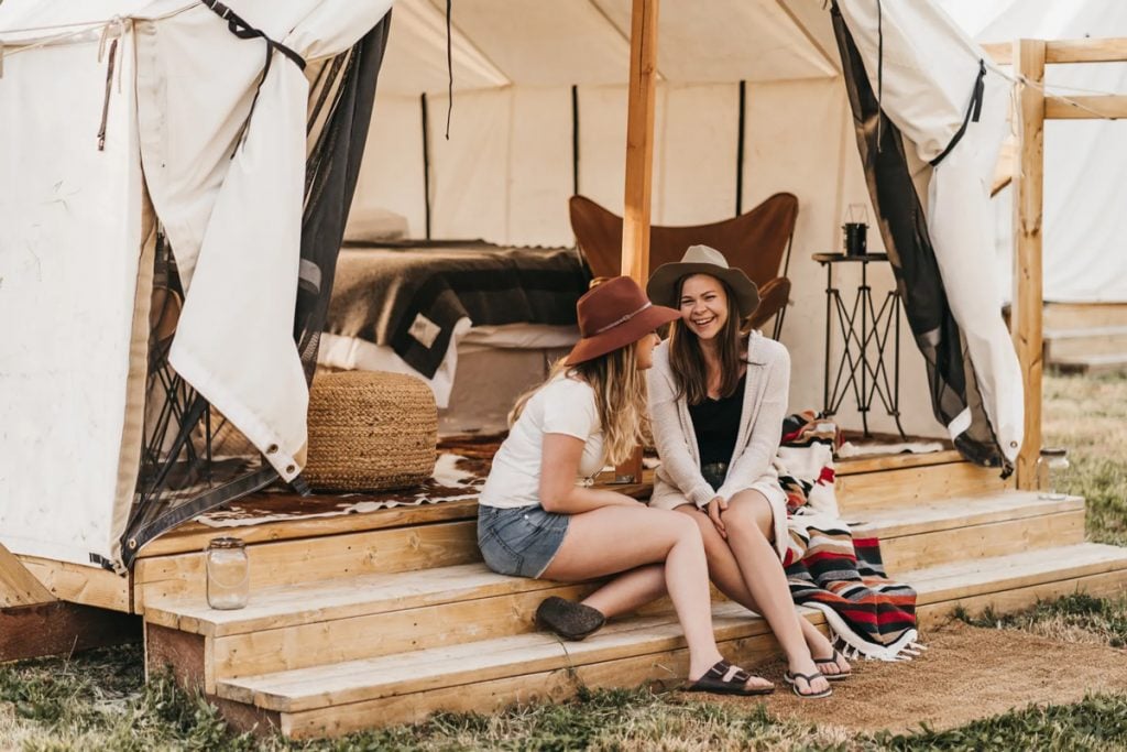 two millennials glamping on a california farm in a luxury camping tent 