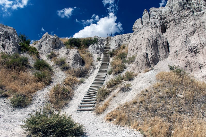 ladder climbing up the notch trail in badlands national park south dakota