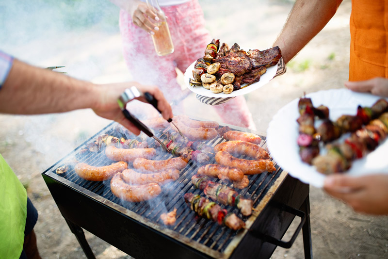 cooking on an outdoor portable grill in an rv park