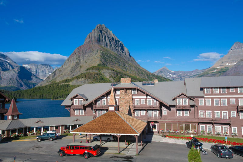 red bus tours outside of the many glacier resort and hotel in montana