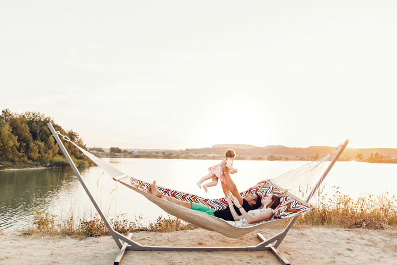 relaxing with a portable hammock stand on a lake