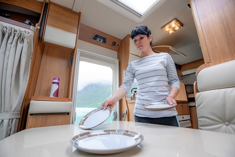 freshly cleaned plates and table settings in an rv