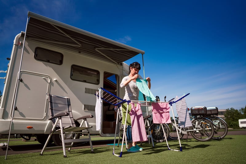 using an rv washer dryer to do laundry while camping in a travel trailer