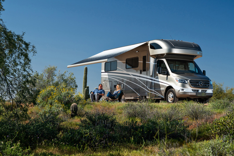 couple camping in a small class c motorhome