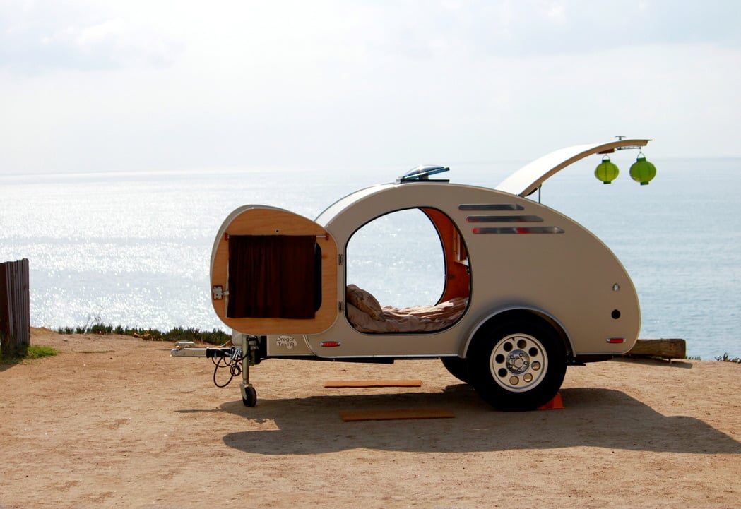 Teardrop camper trailer parked near the beach