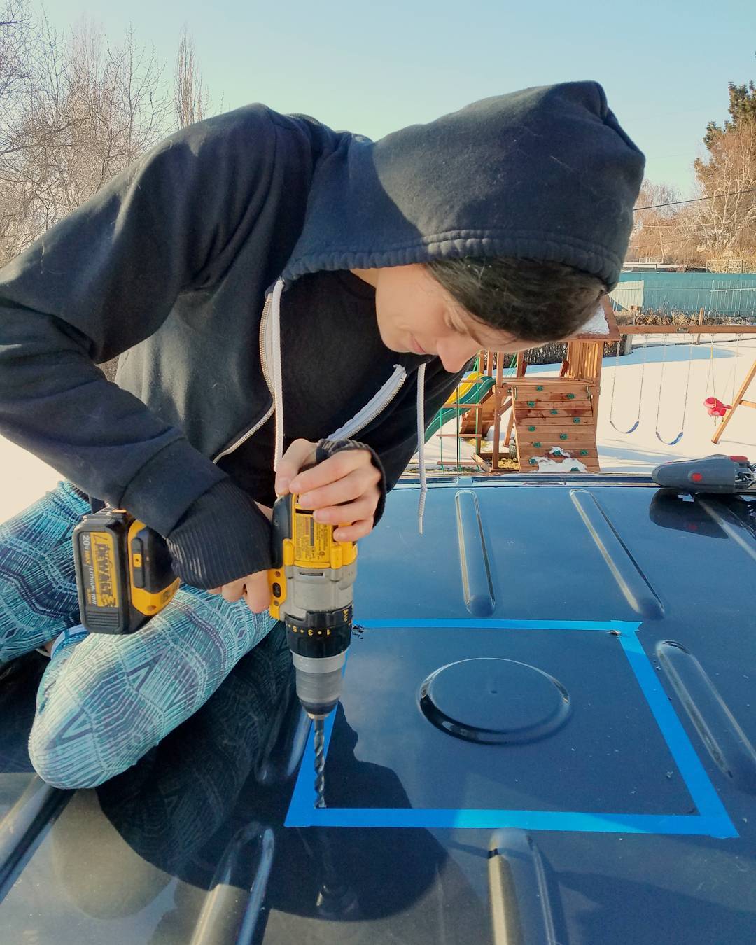 drilling holes in the roof of a campervan