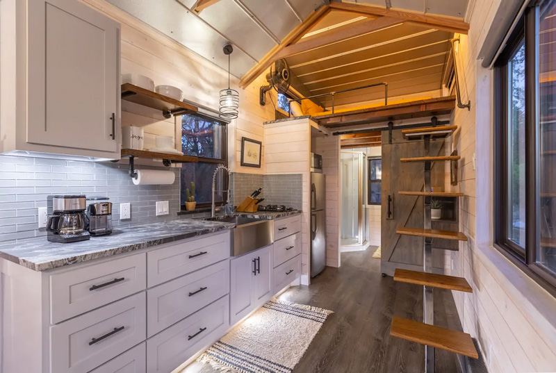 staircase, kitchen and loft in a tiny home