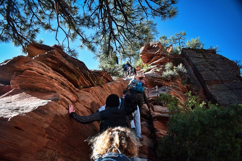 photo of heavy crowds and tourists hiking to the top of angels landing