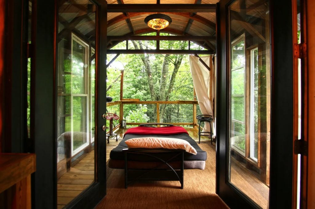 comfortable bed when glamping in a luxury treehouse