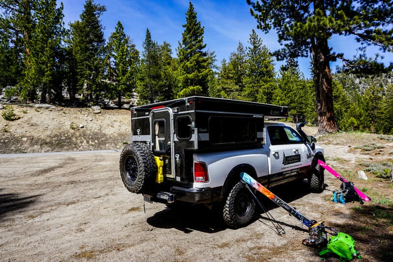 skis sitting outside a pickup truck camper