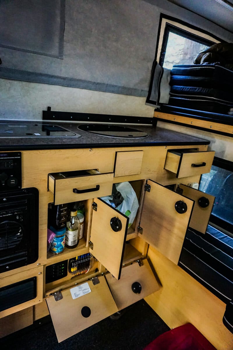 gear and kitchen storage space in a truck camper