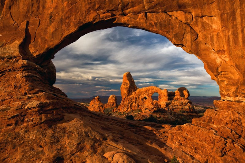view of turret arch through window arch in a utah national park