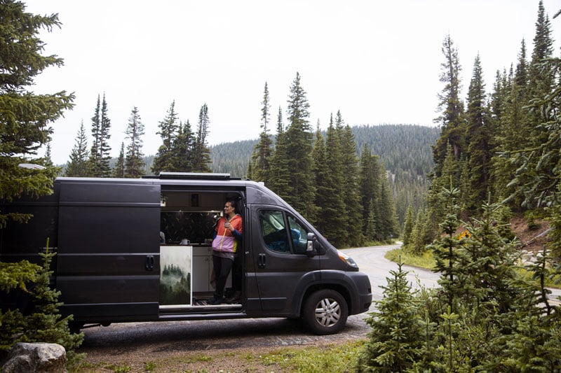 woman camping in a custom camper van conversion