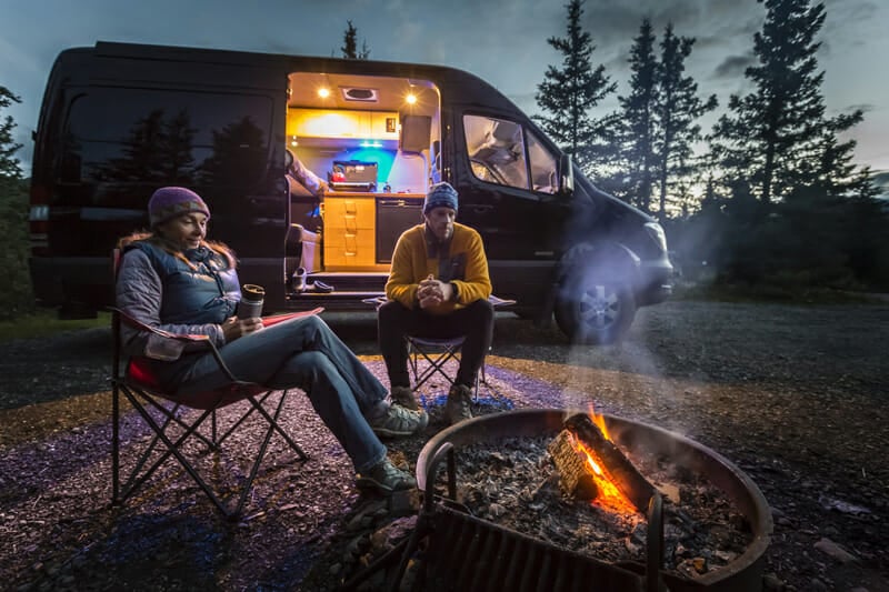 photo of a couple living the van life in a homemade camper van conversion
