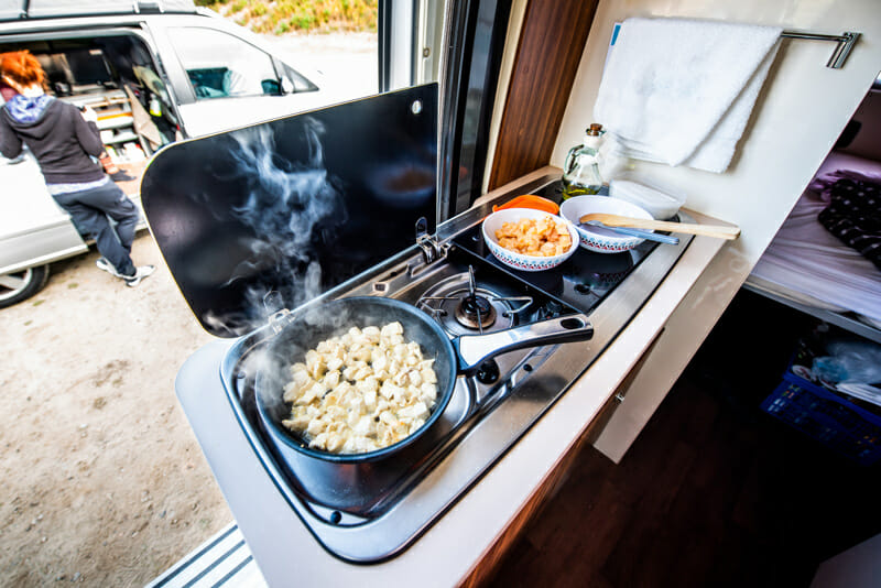 van life cooking in a conversion van