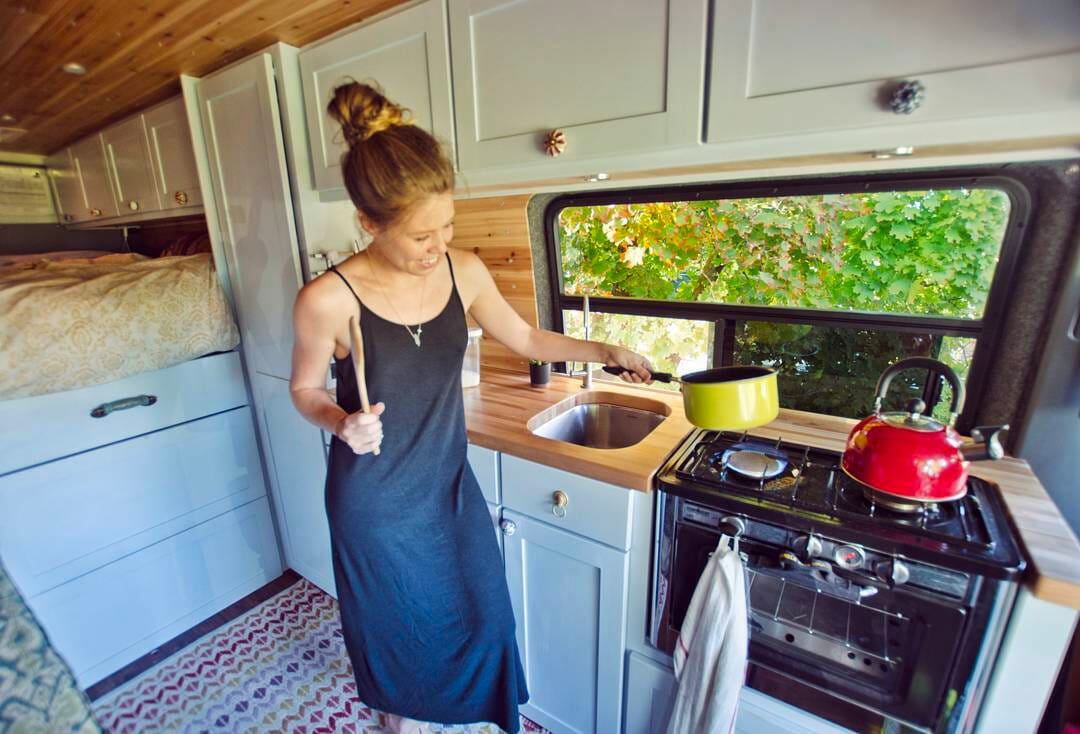 cooking in a DIY campervan conversion kitchen