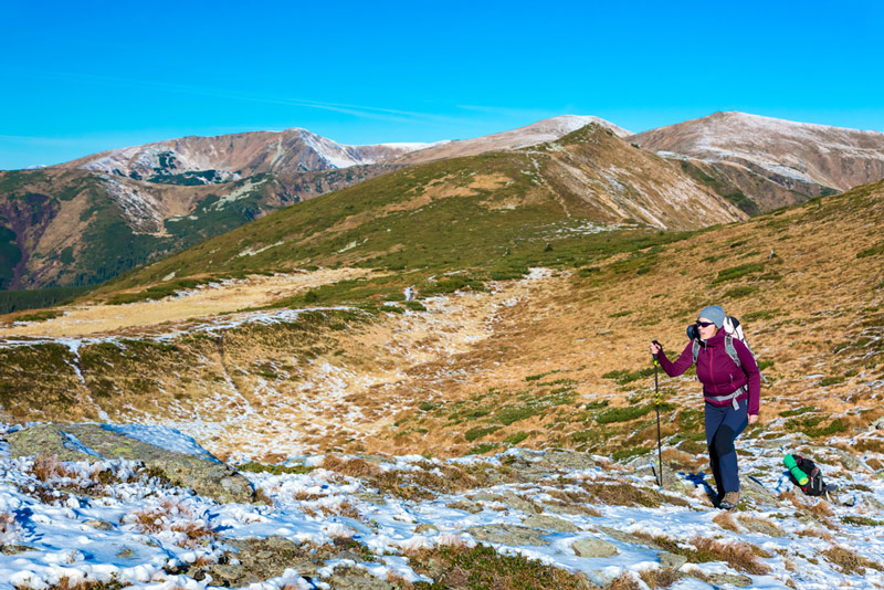 hiking in the winter with a backpack and sleeping pad